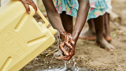 Girl washes hands with clean water