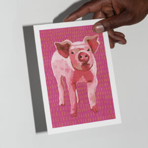 The Piglet card in hand in front of a grey background