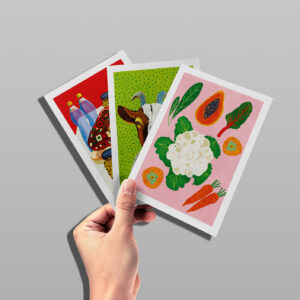 A hand holds three Better World Gift cards representing our Food for Life bundle