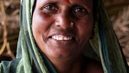 A woman smiles at the camera