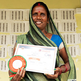 Mina holding a certificate of achievement