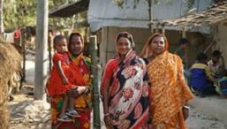 Three women and an infant stand together