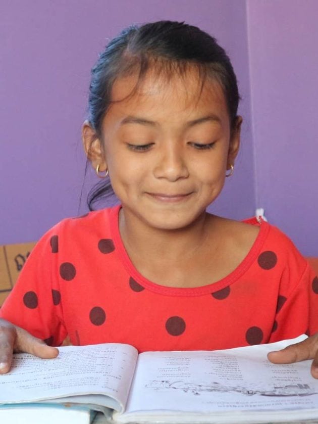 Young Cambodian girl studying indoors