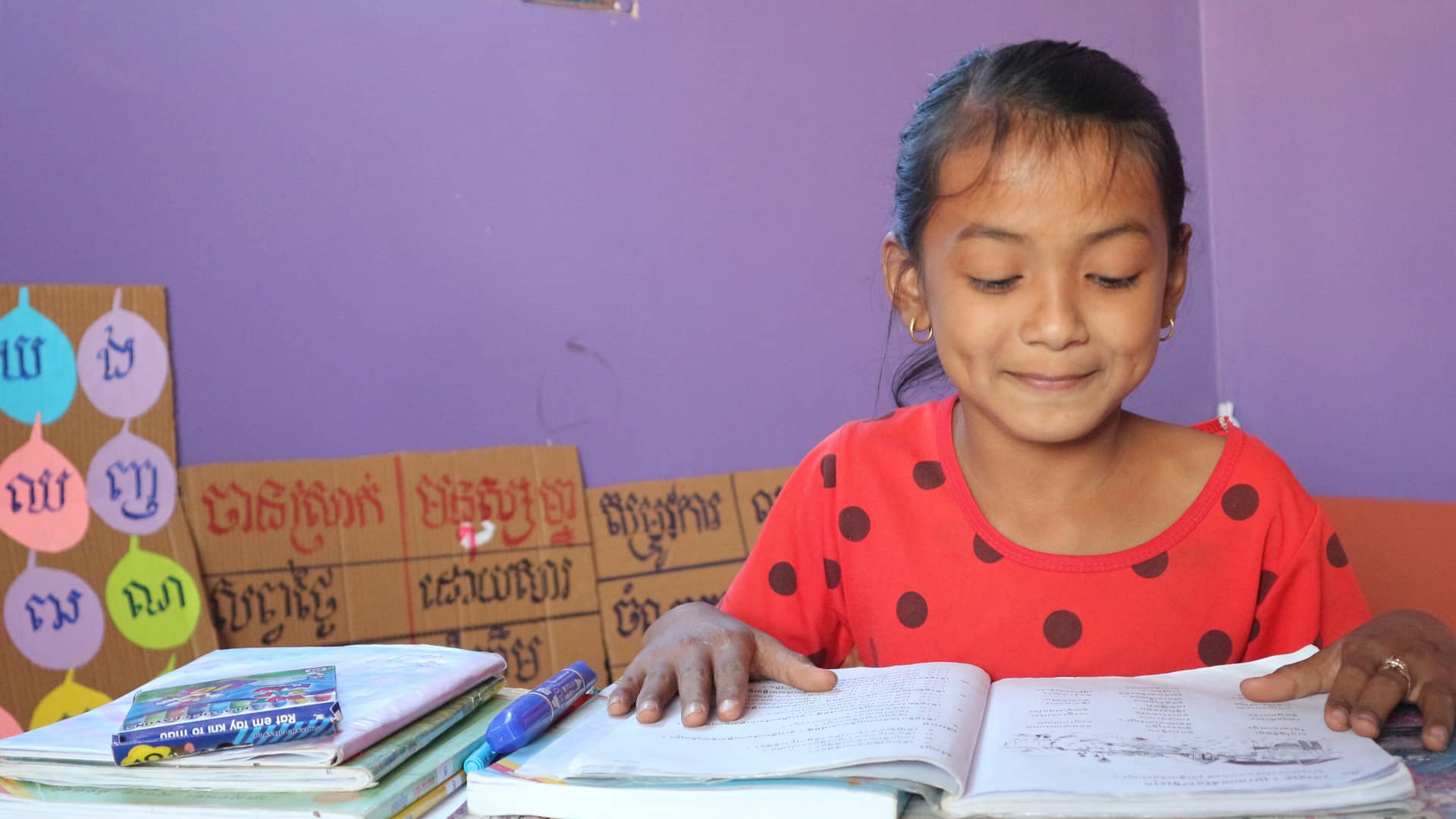 Young Cambodian girl studying indoors