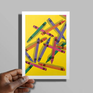 The Arts & Craft card in hand in front of a grey background
