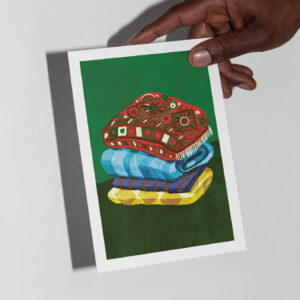 The Blanket card in hand in front of a grey background