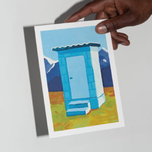 The Toilet card in hand in front of a grey background