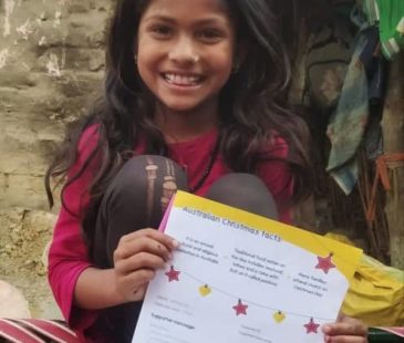 A child holds her Christmas letter from her child sponsor