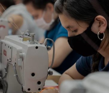 Women in a garment factory sewing garments.