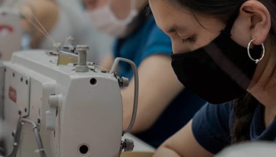 Women in a garment factory sewing garments.