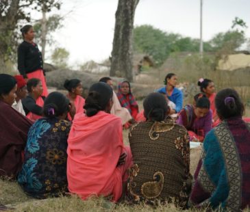 A photo of women sitting in a circle