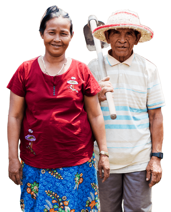 A Cambodian man and woman stand in their yard