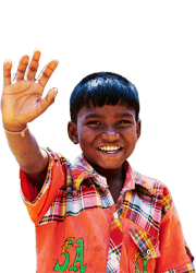 A young Bangladeshi boy smiles and holds his hand up