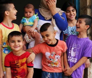 A Syrian refugee mother and her six children