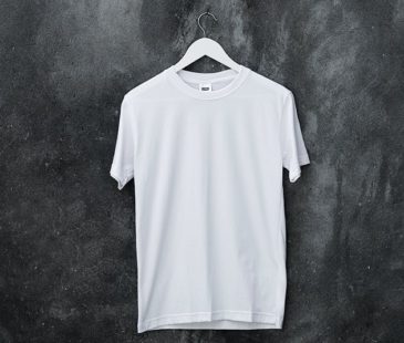 A white t-shirt on a white wooden hanger