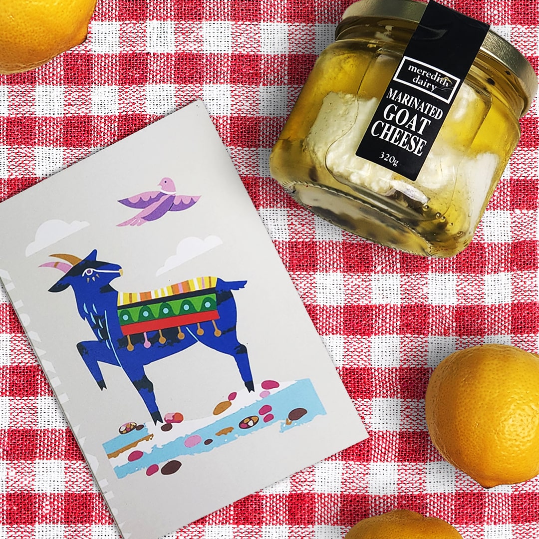 Our Better World goat gift card with goats cheese and lemons on a gingham table cloth