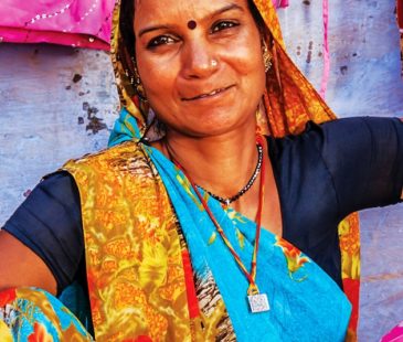 A smiling woman in a sari