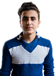 High school boy from Lebanon smiles at camera wearing a blue and white sweater