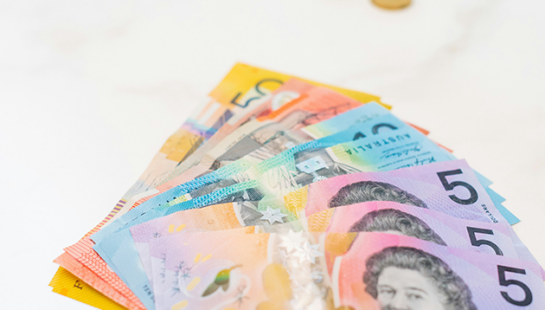 Pile of Australian money on a white bench