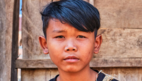 Young boy in Cambodia looking directly at the camera