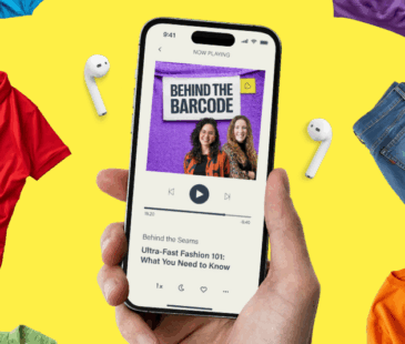 A hand is holding a phone with the Behind The Barcode podcast art on the screen. The background is yellow.
